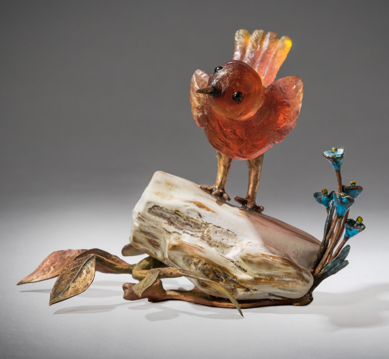 glass sculpture: red bird on log